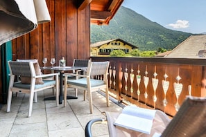 A balcony with wooden furniture and a view of a mountain. - Holiday apartment with 2 bedrooms (Farchant)
