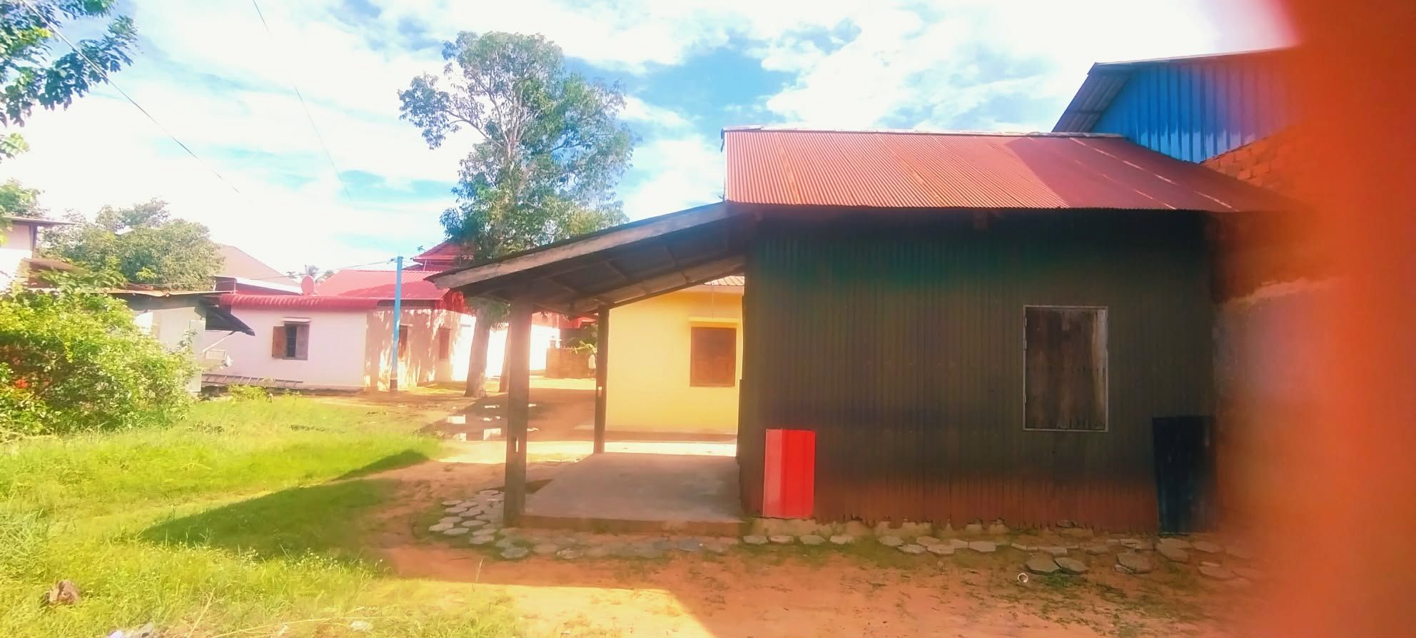 Zona residencial con casas de techos rojos y un camino pavimentado.