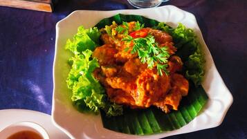 A plate of food with a garnish on a table.