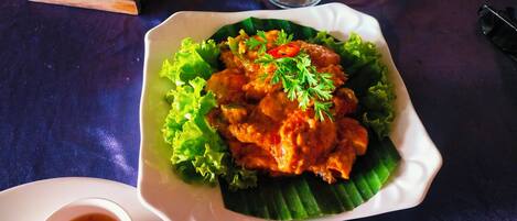 A plate of food with a garnish on a table.