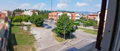 A residential area with a street, parked cars, and buildings.