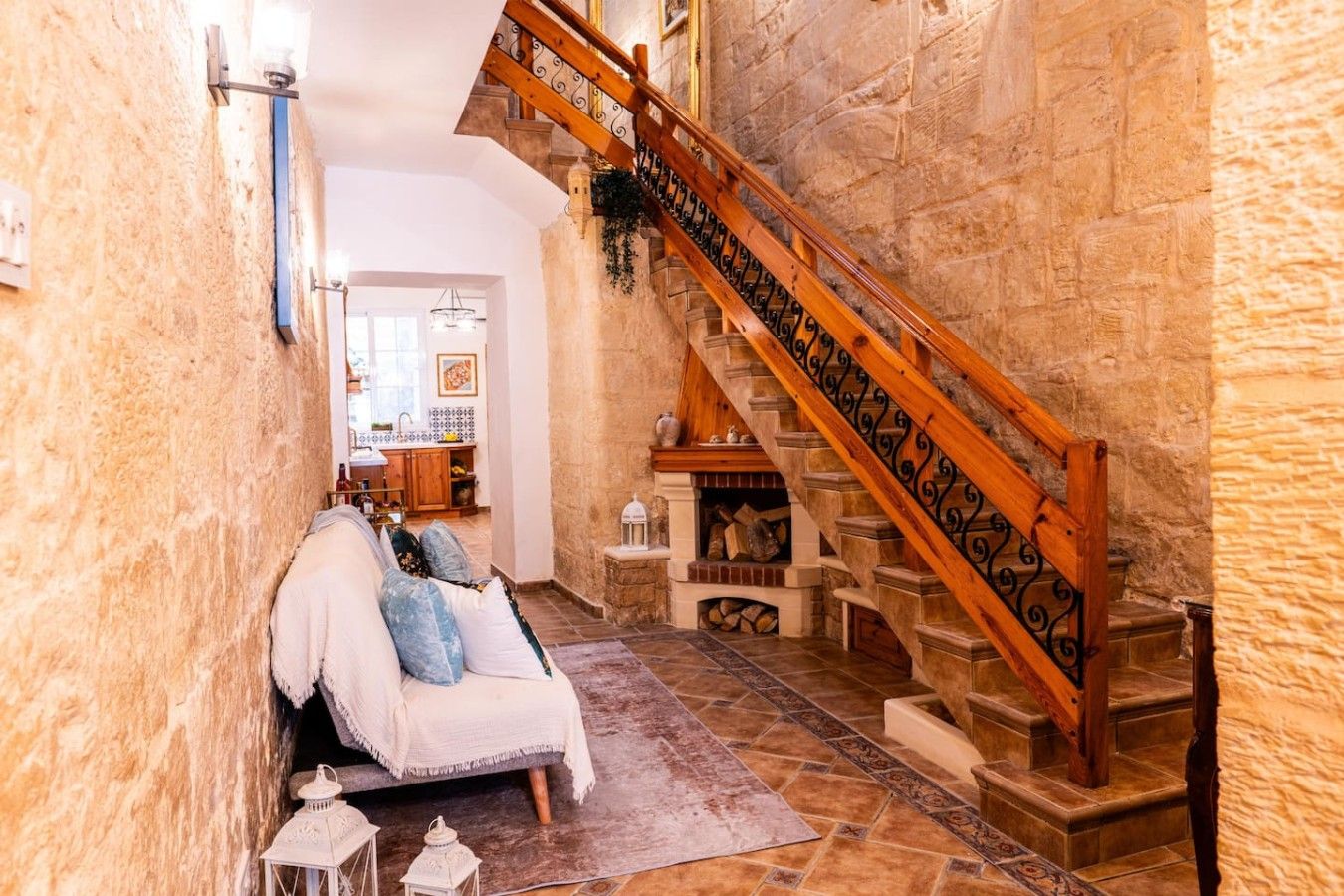 A narrow hallway with a wooden staircase leading to an upper level.