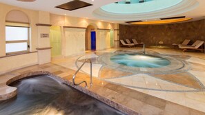 A spa area with a hot tub, a small waterfall feature, and lounge chairs. - Beachfront Cabo Escape at Villa del Arco with Pools, Spa & Walkable Location (Cabo San Lucas)