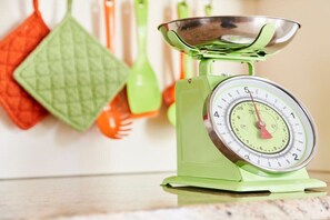A green kitchen scale with a stainless steel bowl on top. - No. 2 - The Lake House (Walchensee)