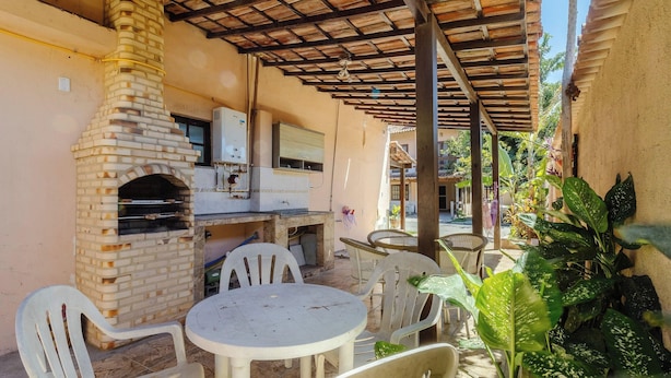 An outdoor patio with a brick oven, a water heater, and a tiled floor. - House in Cond. w/ Pool - Cabo Frio Vdp0029 (Cabo Frio)