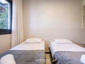 A room with two beds, a window with curtains, and a view of greenery outside. - Apart in Condo With Pool, Praia do Forte Vlpc0103 (Mata de São João)