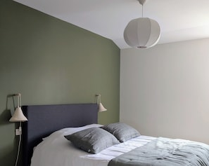 A bedroom with a bed, two bedside lamps, and a hanging light fixture. - L'Atelier (Saint-Just-près-Brioude)