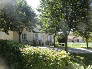 A building with a traditional architectural style, surrounded by lush greenery and a well-maintained lawn. - Château de Villers – Hunting Lodge – West Wing (Villers-en-Argonne)