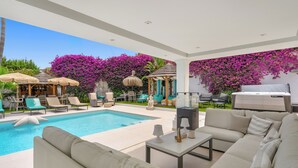 A modern outdoor pool area with lounge chairs, a sofa, and a dining table. - Luxury villa in Marbella (Marbella)