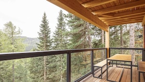 A wooden deck with a table and chairs, overlooking a forested area. - Superior Chalet #15 With Sauna & Hot Tub (Stadl-Predlitz)