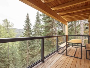 A wooden deck with a table and chairs, overlooking a forested area. - Superior Chalet #15 With Sauna & Hot Tub (Stadl-Predlitz)