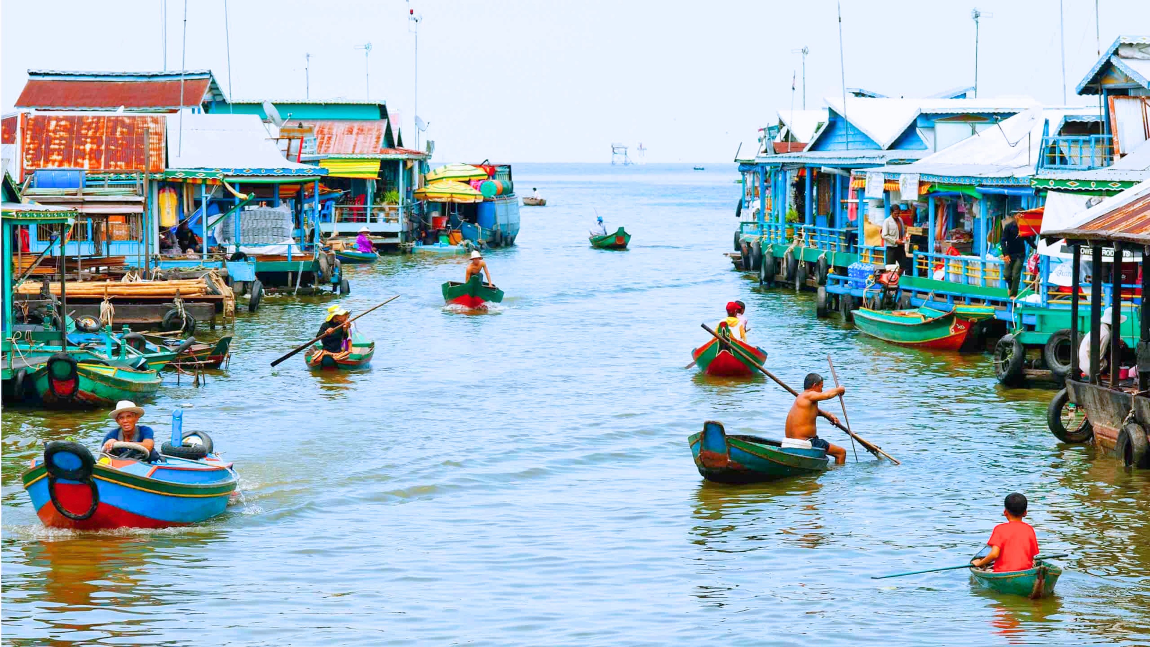 A waterway with boats and floating houses.