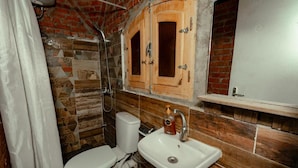 A bathroom with a toilet, sink, and wooden cabinets. - Krouma Camp & Ecolodge (Aswan)