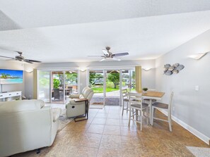 A spacious living area with a sofa, a dining table with chairs, and a ceiling fan. - Whether you're bringing your boat, planning a family vacation, or simply looking for a peaceful coastal retreat, this home delivers an unforgettable Space Coast experience. (Cocoa Beach)