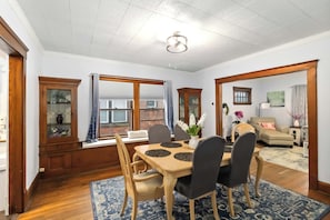A dining area with a wooden table, chairs, and a blue patterned rug. - Extremely walkable Lakewood, Central location (Lakewood)