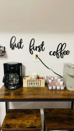 A coffee station with a coffee maker, a box labeled 'HOMEBREW & CO. COFFEE HOUSE,' and a tray of coffee cups. - Lakewood Park Top Floor, Free parking (Lakewood)