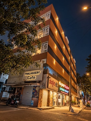 A multi-story building with a Thai restaurant on the ground floor. - Petals Suites & Hotels (Bengaluru)