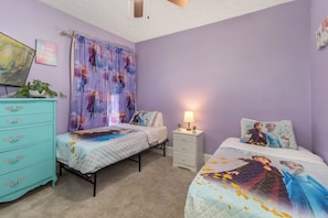 A bedroom with two beds, a dresser, a nightstand, and a ceiling fan. - ✨ Family-Friendly Charm in the Heart of Lakewood 🌿<br>Steps from Parks, Trails & Lake Views<br>Welcome to your serene escape in Lakewood—where convenience meets charm in one of Cleveland’s most walkable neighborhoods. (Lakewood)