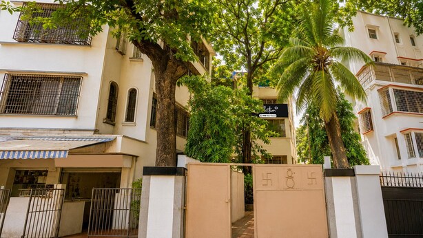 A gated entrance to a building with a sign indicating it is serviced by OYO. - Classic Santacruz Metro Station (Mumbai)