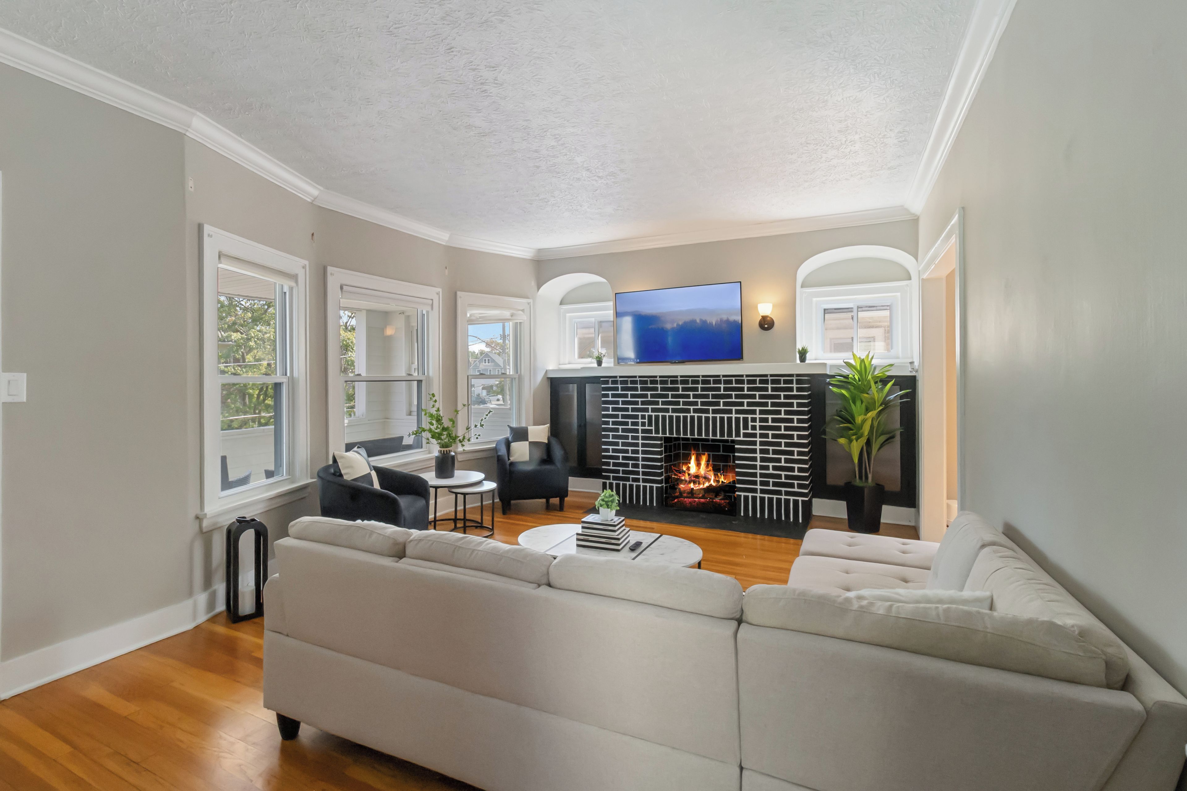 A living room with a fireplace, a television, and a sofa.