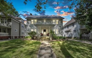 A two-story house with a front porch, a stone pathway leading to the entrance, and a well-maintained lawn. - Central West Blvd 2bedroom Apartment close to HWY (Cleveland)