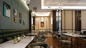 A restaurant interior with a long counter, booths, and a high ceiling with a skylight. - Paco Hotel Chimelong Nancun Wanbo Metro (Guangzhou)