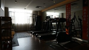A gym with treadmills, exercise bikes, and a mirrored wall. - Paco Hotel Chimelong Nancun Wanbo Metro (Guangzhou)