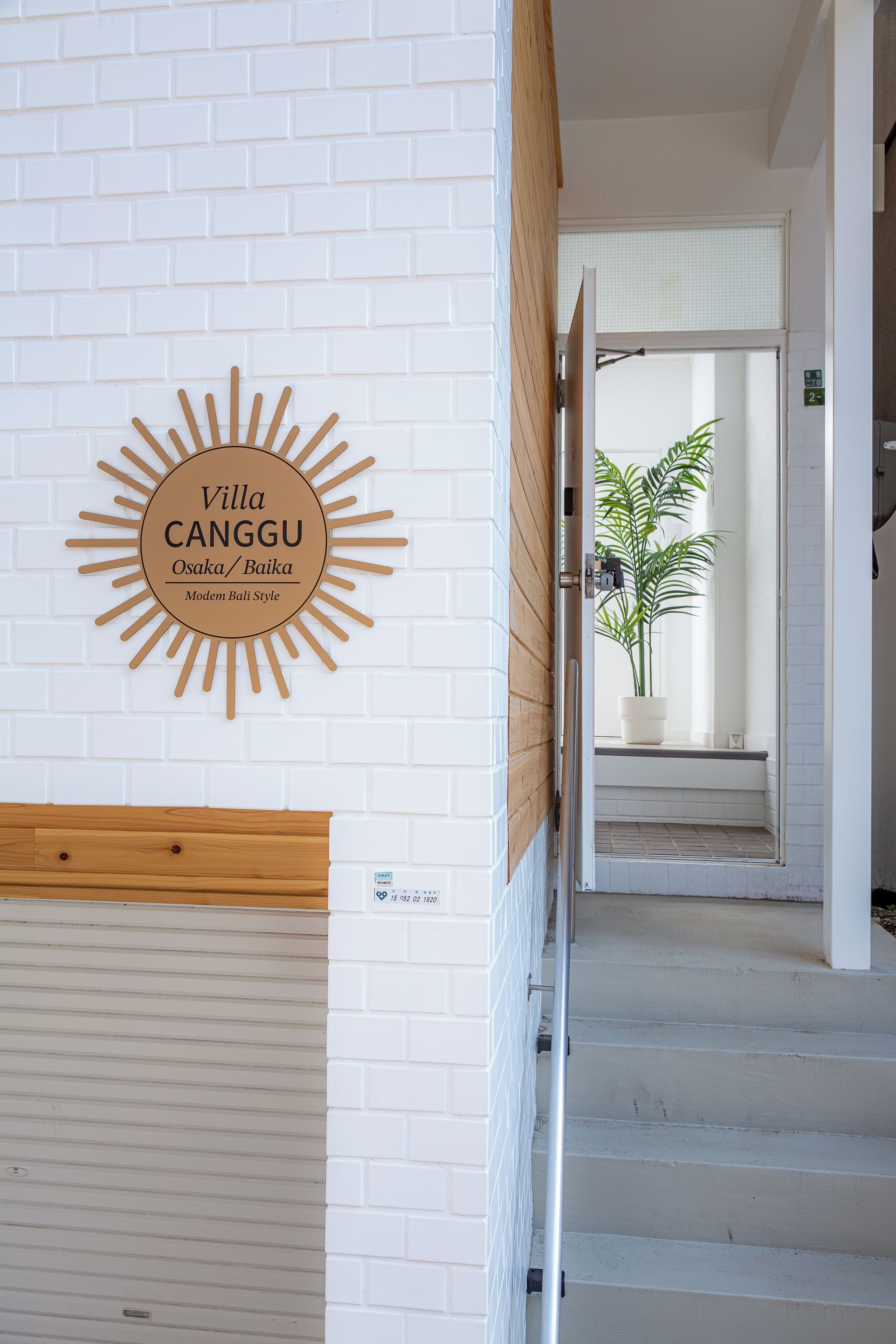 A hotel entrance with a sign for 'Villa Canggu' and a staircase leading inside.