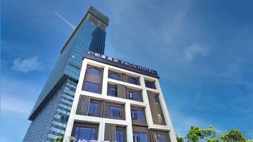 A multi-story building with a sign for 'Paco Hotel' at the top.