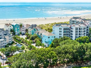 A coastal residential area with beachfront properties, including multi-story buildings with balconies and a beach in the background. - Atlantic High- 1 Summer Dunes-  Sleeps 22, PeekaBoo Views & Elevator! (Isle of Palms)