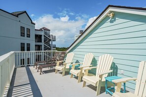 A balcony with Adirondack chairs and a view of a building with multiple windows and a balcony. - Atlantic High- 1 Summer Dunes-  Sleeps 22, PeekaBoo Views & Elevator! (Isle of Palms)