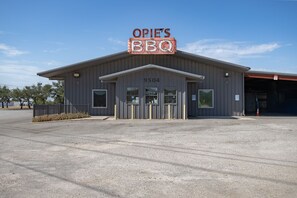 A building with a sign reading 'OPIE'S BBQ' and the number '9504' on the facade.