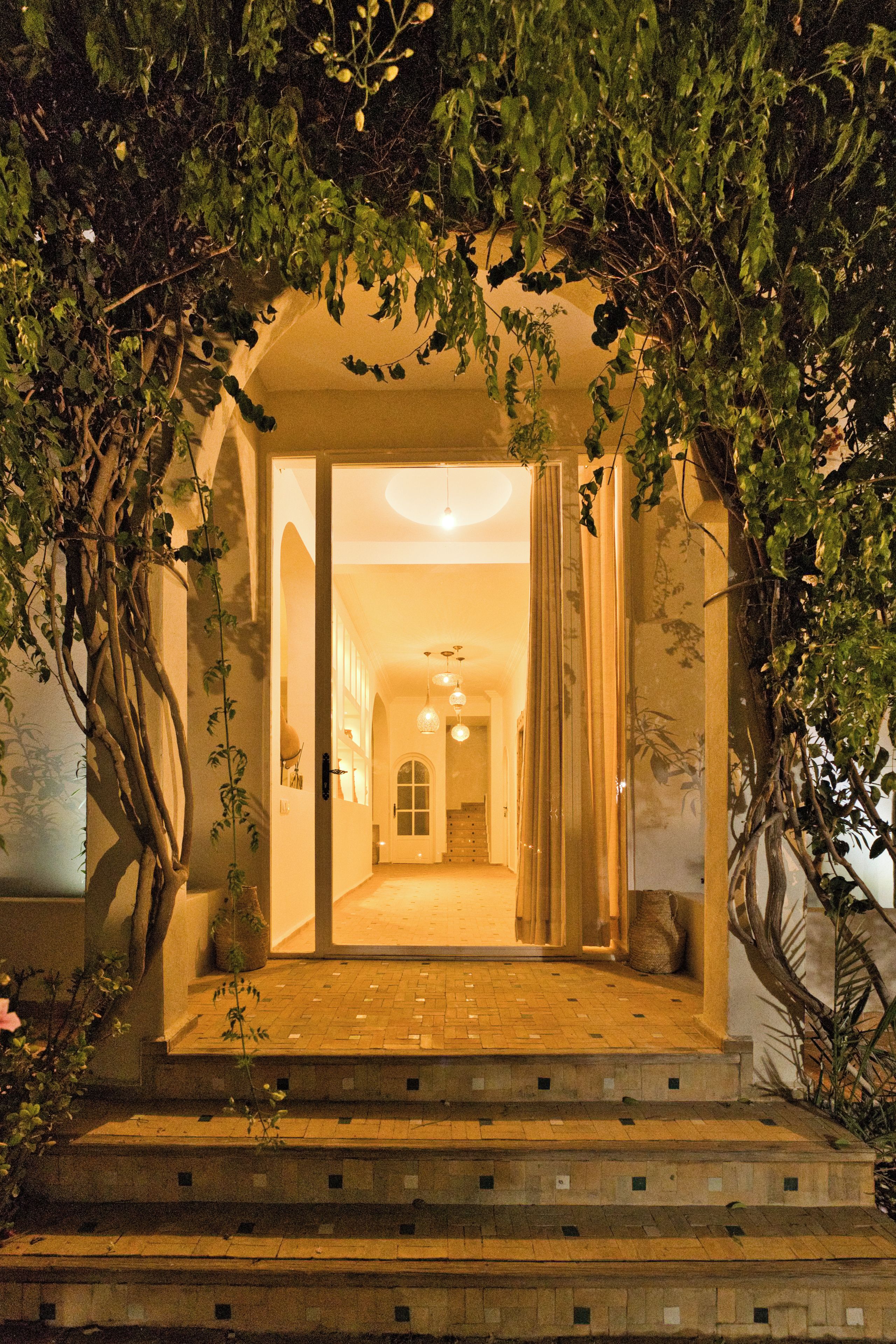 A building entrance with a covered pathway leading to an interior space.