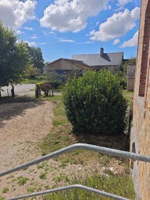 A residential area with a house, a fenced yard, and a gravel path. - Meurdrac's Rest (La Meurdraquière)