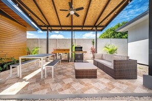 A covered patio with a ceiling fan, outdoor furniture, a barbecue grill, and a stone wall. - Studio w/ Shared Pool < 1 Mi to Playas Del Coco! (Sardinal)