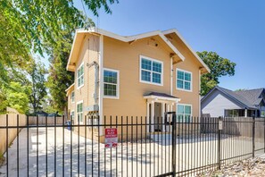 A two-story house with a front porch, a fenced driveway, and a 'DO NOT BLOCK DRIVEWAY' sign. - 2 Mi to Downtown! Central San Antonio Rental (San Antonio)