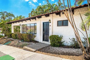 A single-story building with a tiled roof, a black door, and a small window. - Playa Hermosa Villa w/ Plunge Pool & Shuttle! (Sardinal)