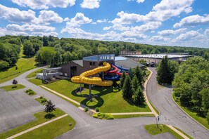 A playground with multiple slides and a building with a flat roof. - The Ultimate Lake Harmony Group Getaway Awaits! (Lake Harmony)