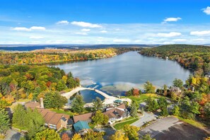 A lakeside residential area with houses, a marina, and autumn foliage. - The Ultimate Lake Harmony Group Getaway Awaits! (Lake Harmony)