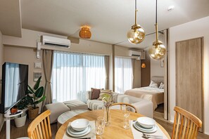 A modern hotel room with a dining area, two beds, and a large window with curtains. - BRANCHERA NAHA KAINAN PREMIST - 1502 (Naha)