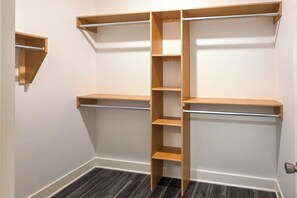 A closet with open shelves and a central hanging rod. - Walk to Parks & Dining! Newly Built Wichita Condo (Wichita)