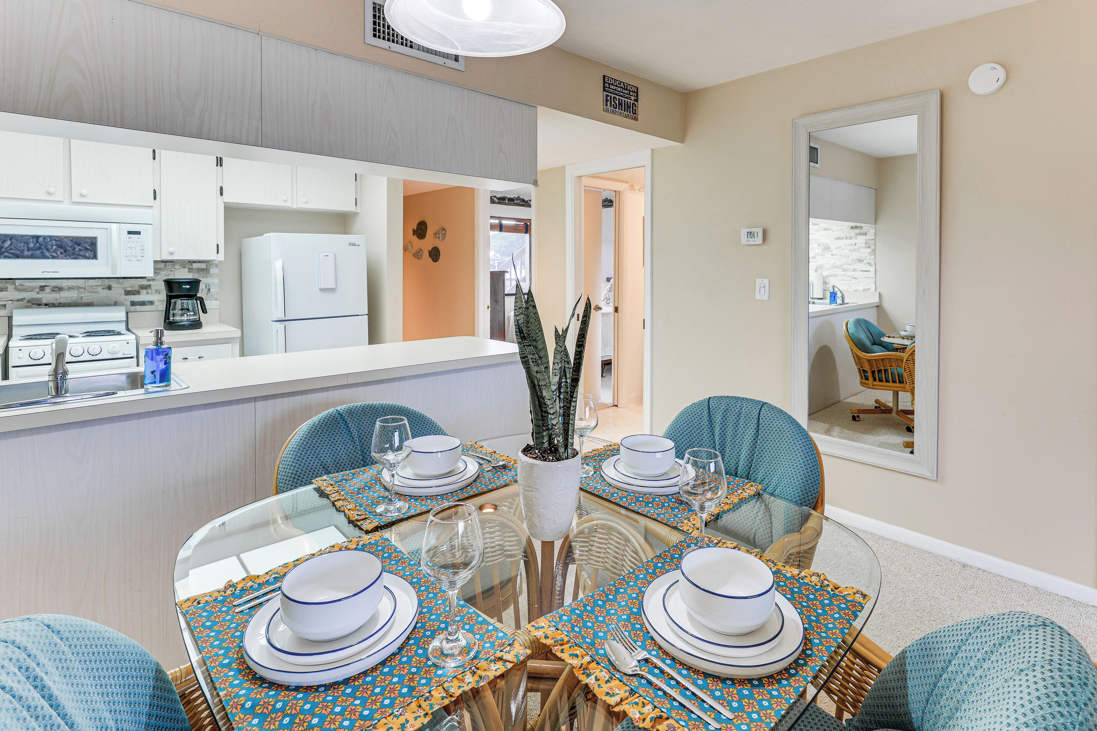 A modern kitchen with white cabinets, a refrigerator, and a coffee maker.
