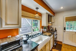 A kitchen with a built-in oven, a sink, and a stove.
