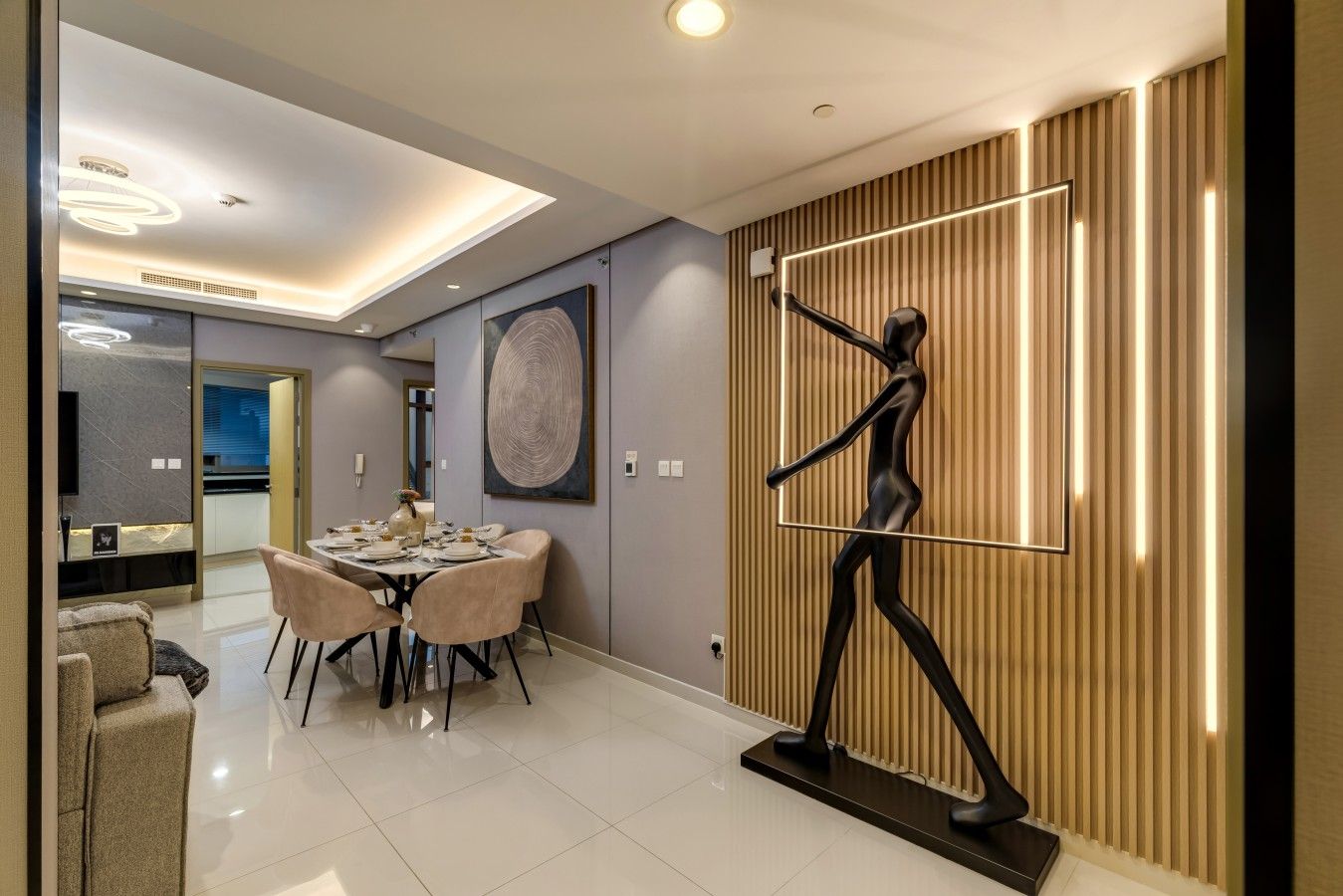 A modern interior with a dining area, a large abstract painting, and a unique wall sculpture.