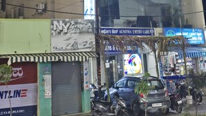 A multi-story building with signage for 'Blackrooms' and 'Vasan Eye Care.'