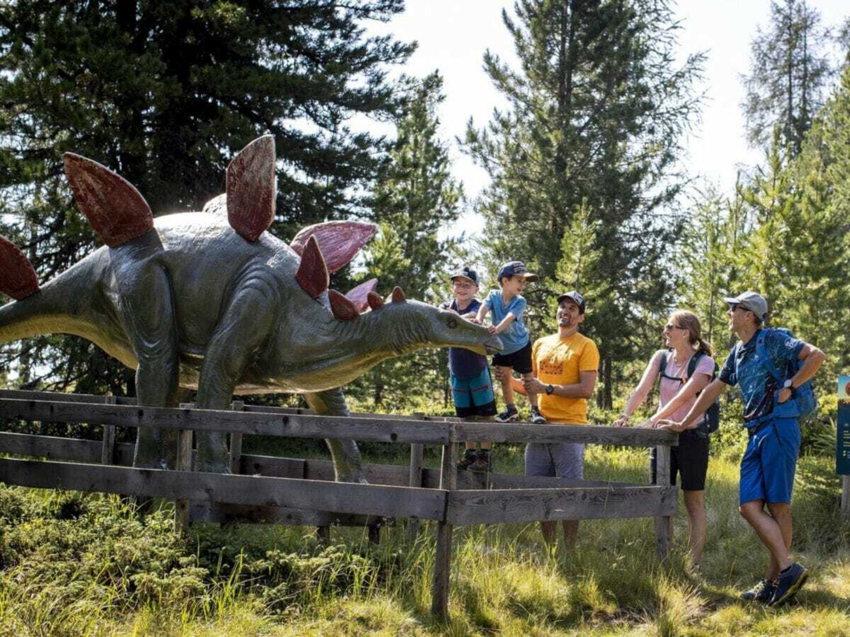 A dinosaur exhibit with visitors observing.