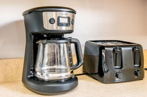 A coffee maker with a glass carafe and a toaster on a countertop. - 301 Chester Street: 2  BR, 2  BA Condominium in Myrtle Beach, Sleeps 7 (Myrtle Beach)