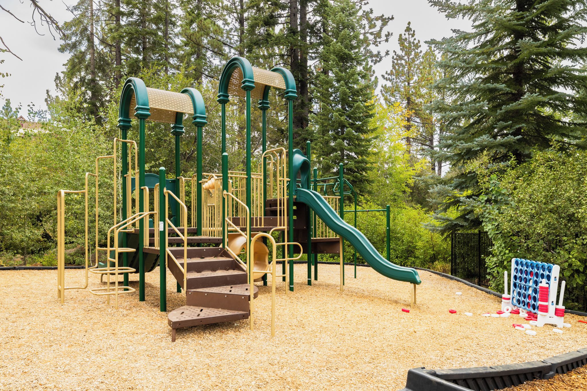 A playground with a slide, climbing structures, and a ball pit.