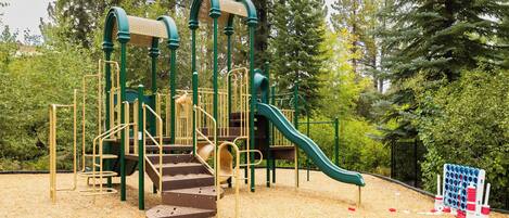 A playground with a slide, climbing structures, and a ball pit.