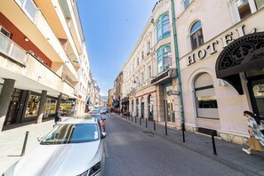 A street with buildings, including a hotel with a sign.